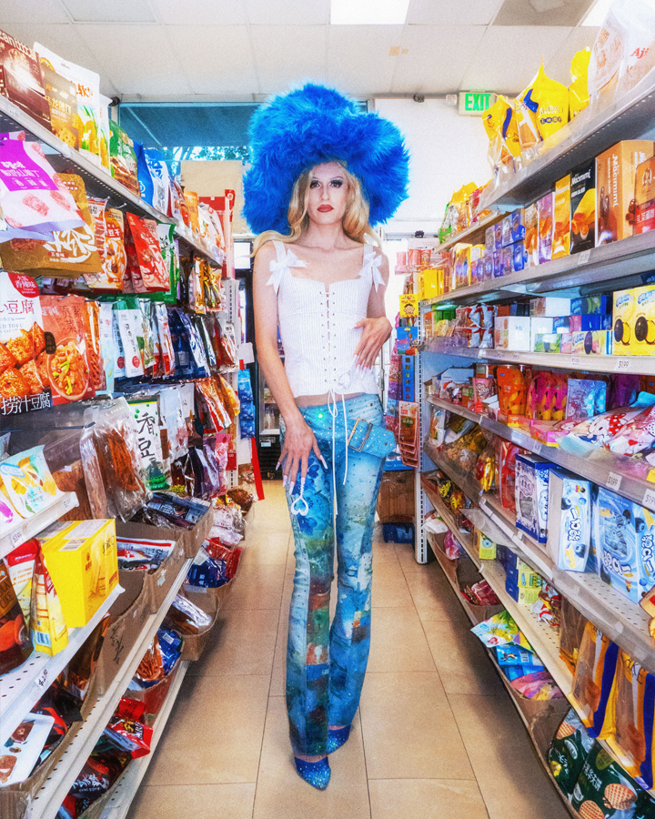 Jesse Clark in y2k inspired drag posing in a colorful conveince store.